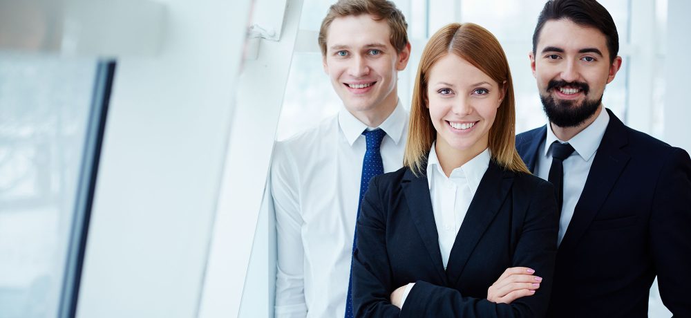 Three successful business partners looking at camera with smiles